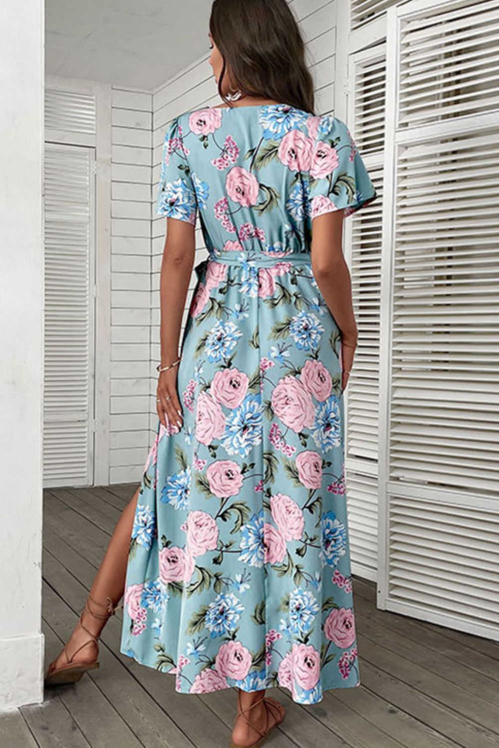 Woman wearing blue floral tie-waist surplice maxi dress