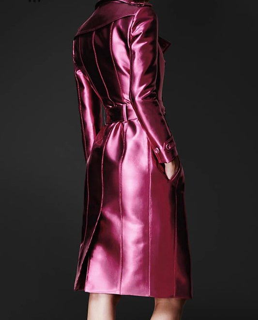 Person wearing a glossy pink trench coat with 'Lautaro' branding on a dark background