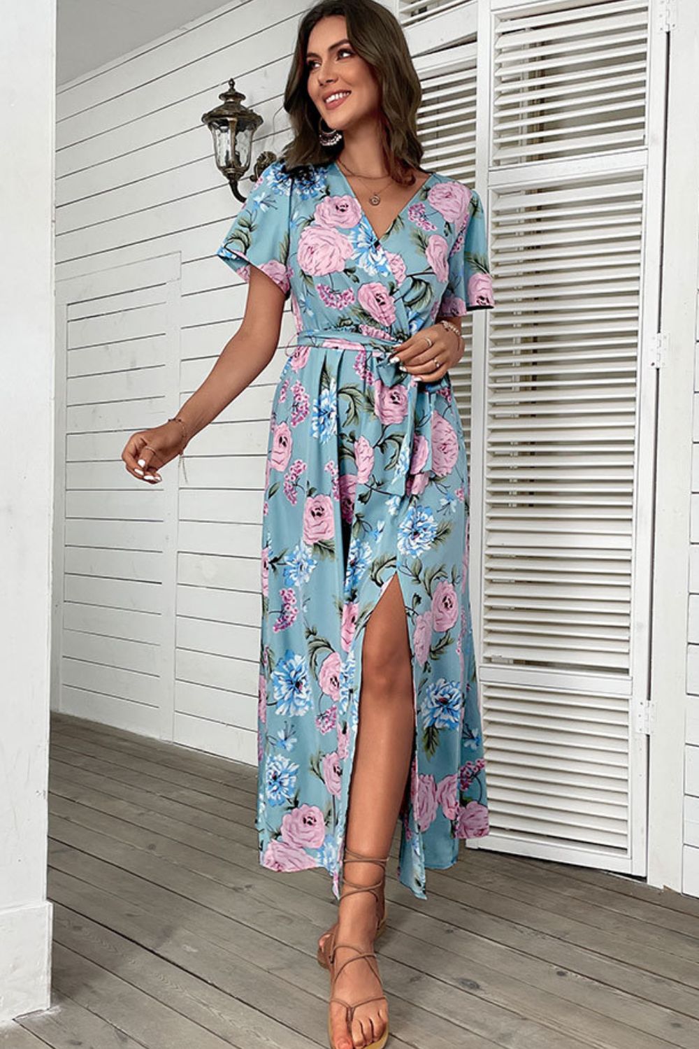 Woman wearing floral print side slit surplice maxi dress