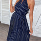 Woman wearing navy blue polka dot midi dress
