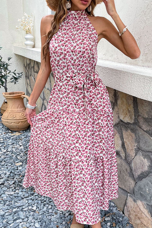 Woman wearing pink floral print halter neck midi dress